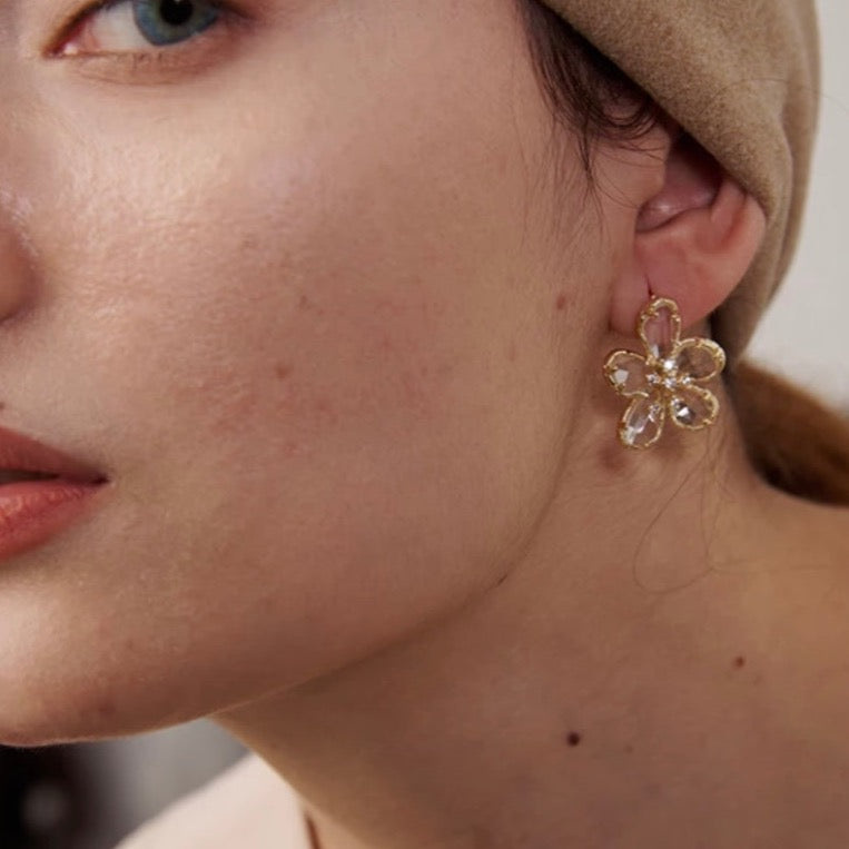 Small golden flower stud earrings with delicate, minimalist design