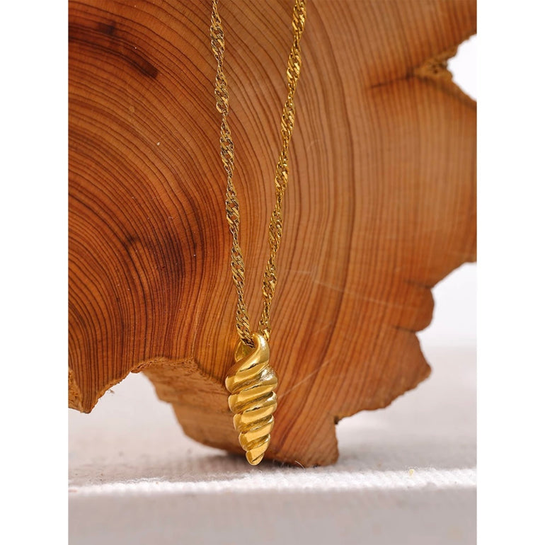 A close up of an 18k gold conch pendant necklace on a white background. The pendant is designed with a minimalist, dainty style and is perfect for adding a touch of the ocean to any summer jewelry collection.