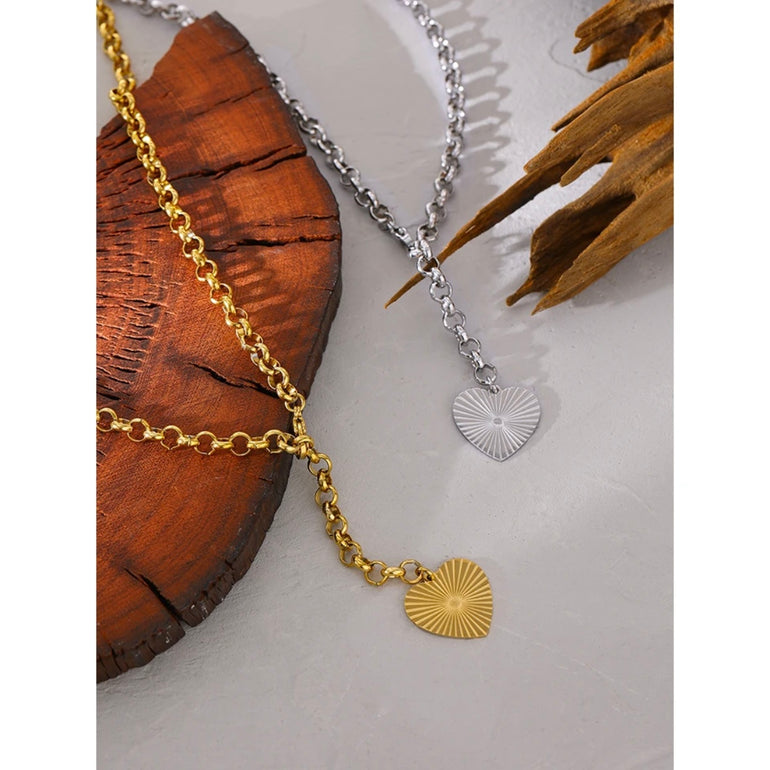 Hammered Heart Pendant with radiant sun rays, water-resistant material, and hammered texture for a chic and stylish look. Ideal for minimalist fans seeking a versatile accessory