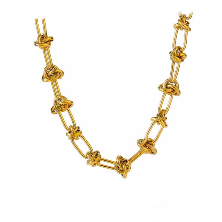 A close-up of the Elegant Gold-Plated Steel Knot Link Chain Necklace with a knot design. The necklace is plated in 18K gold, giving it a luxurious shine. Perfect for daily wear or special occasions, it adds a touch of sophistication to any outfit
