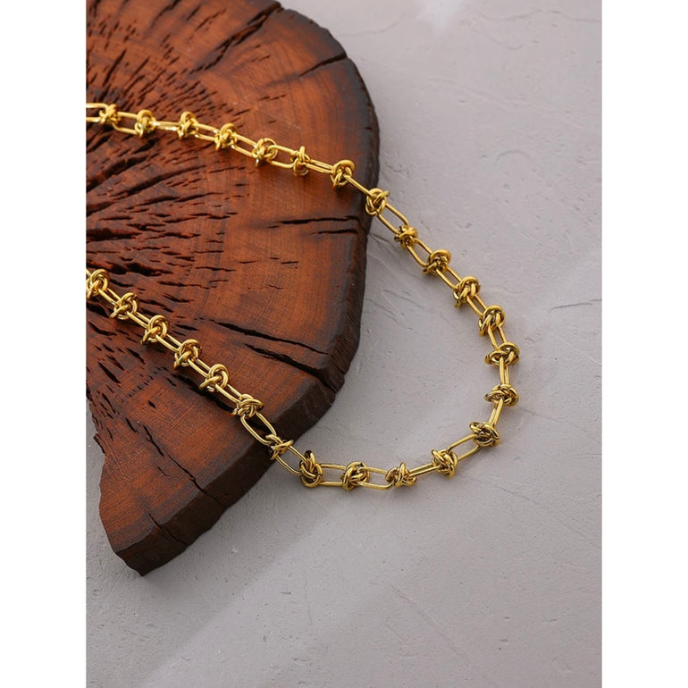 A close-up of the Elegant Gold-Plated Steel Knot Link Chain Necklace with a knot design. The necklace is plated in 18K gold, giving it a luxurious shine. Perfect for daily wear or special occasions, it adds a touch of sophistication to any outfit