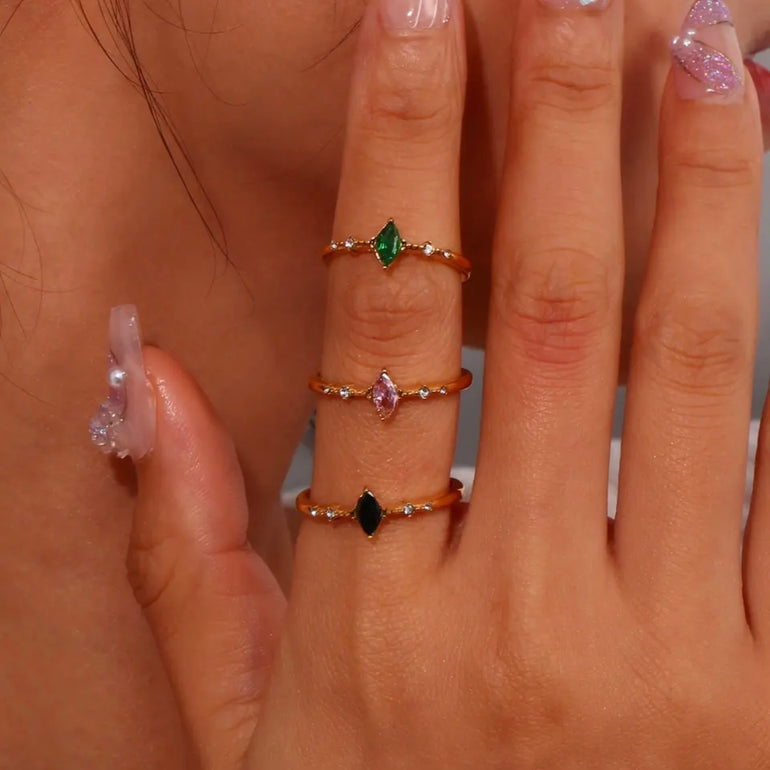 Three dainty diamond rings in black, green, and pink, perfect for adding a subtle touch of glamour to your prom look in Australia