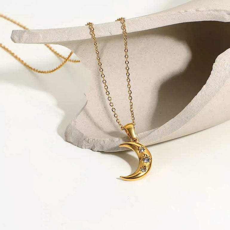 18K solid gold crescent moon pendant and charm necklace for women. The simple necklace has 3 diamonds and real gold that is tarnish free, waterproof and sweat proof jewelry. 